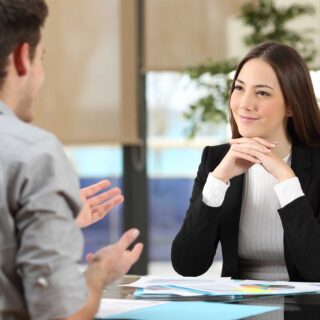 Businesswoman attending listening to a client who is talking at office